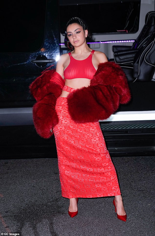 Braless Charli Xcx Showcases Her Toned Midriff In Red Sheer Crop Top