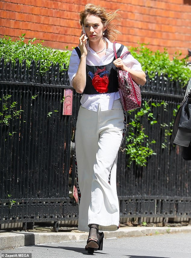 Myleene Klass embraces the sunshine in a coral frilled dress and white