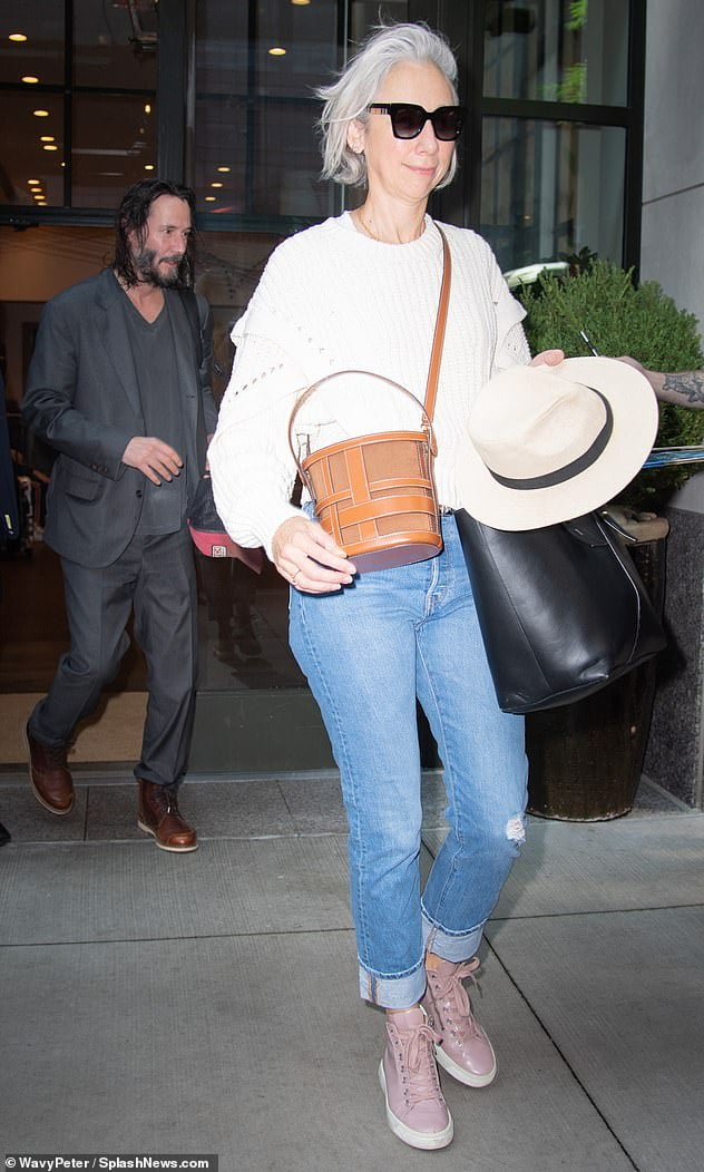 Keanu Reeves and girlfriend Alexandra Grant smile and greet fans as