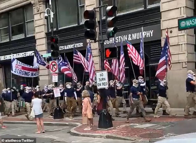 Moment 100 Patriot Front white supremacist group members march along ...