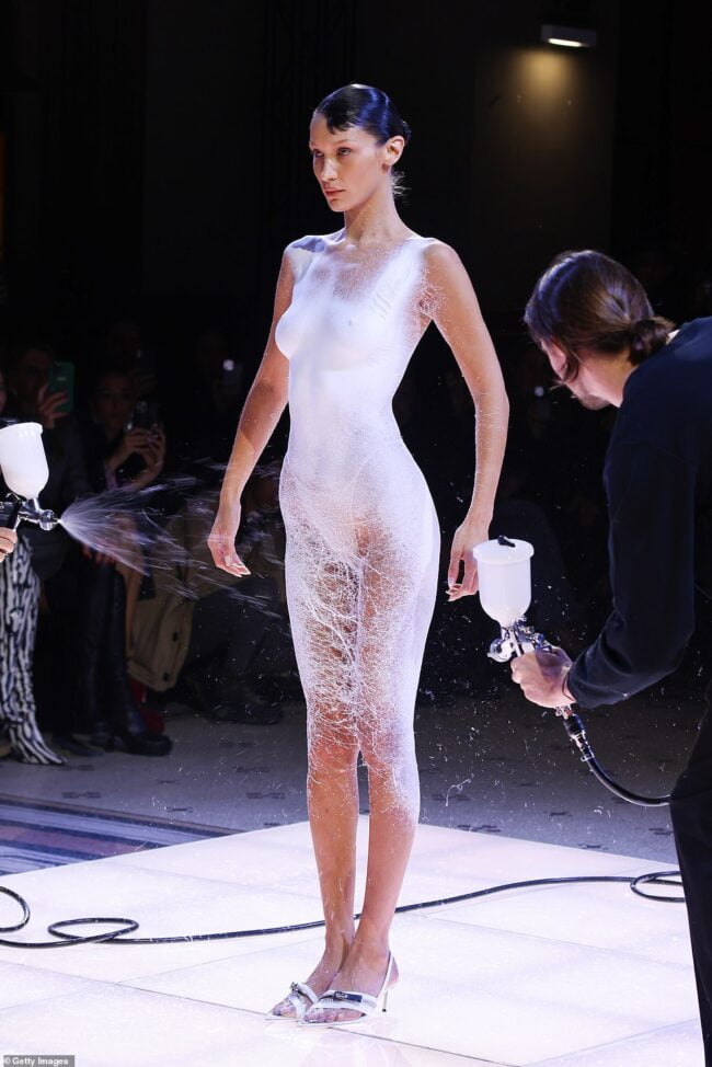 Bella Hadid Takes To The Runway Nude Before Her Dress Is SPRAYED ON In An Incredible Moment At