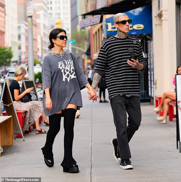 Kourtney Kardashian wears a top from Travis Barker's band Blink 182 in