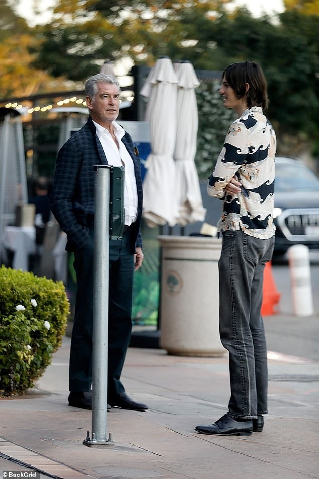 Pierce Brosnan cuts a dapper figure as he takes wife Keely and son