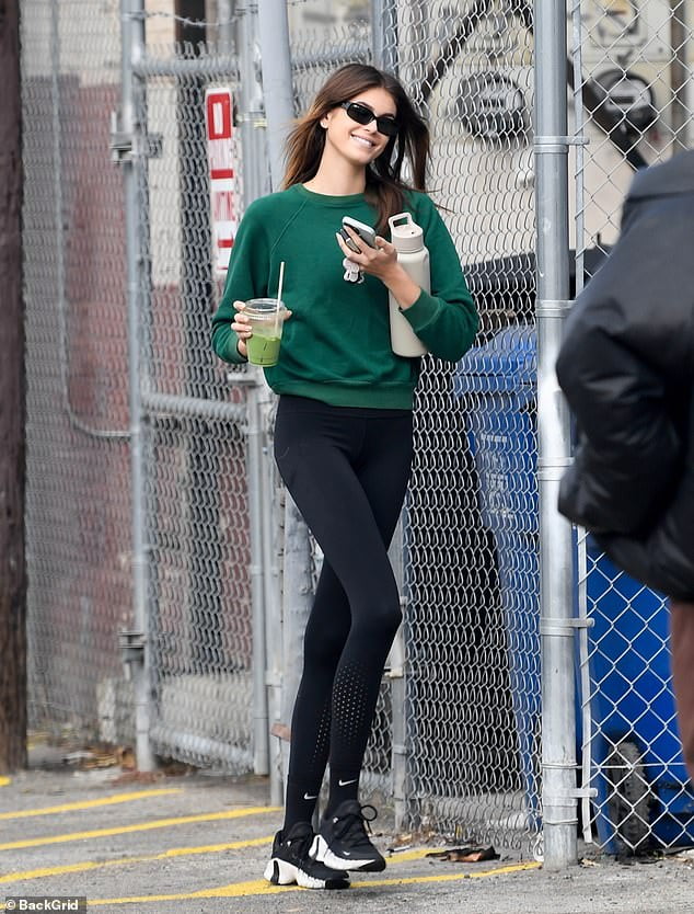 Kaia Gerber nails casual chic in a green sweater and tight leggings