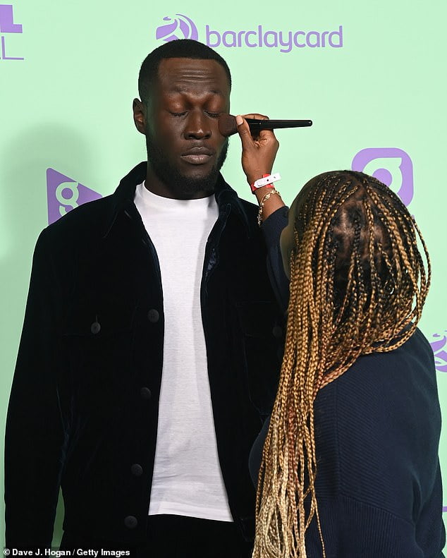 Stormzy has his make-up touched up on the red carpet at Capital's