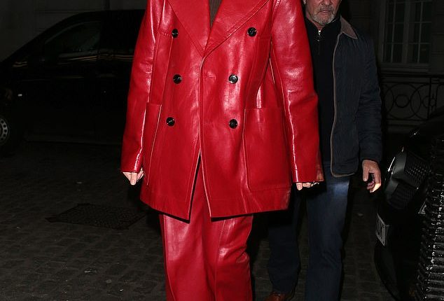 Margot Robbie slips into a stylish red leather coat as she attends the