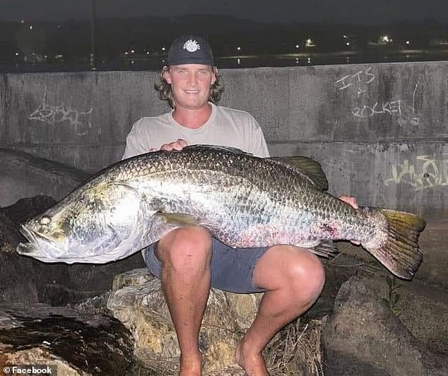 Gold Coast fisherman reels in massive barramundi after fighting off a