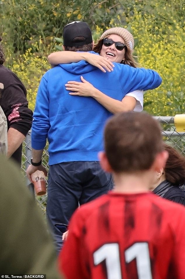 Olivia Wilde and ex Jason Sudeikis share an embrace while cheering on