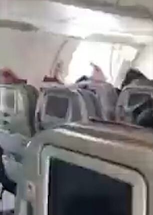 Terrifying moment plane door OPENS in mid-air when traveller grabs ...
