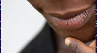 Close-up of a woman's lips with a off-white background and Dark Upper Lip