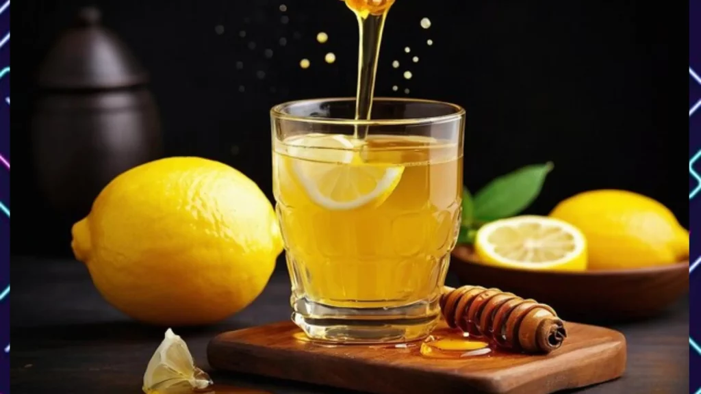 A clear glass of lemon water on a wooden board with slice of lemon, surrounded by lemon and honey drooping into the glass.