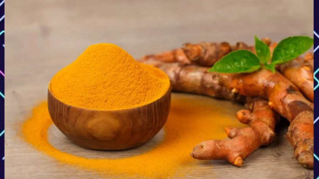 A wooden bowl filled with tumeric powder next to a pile of fresh tumeric